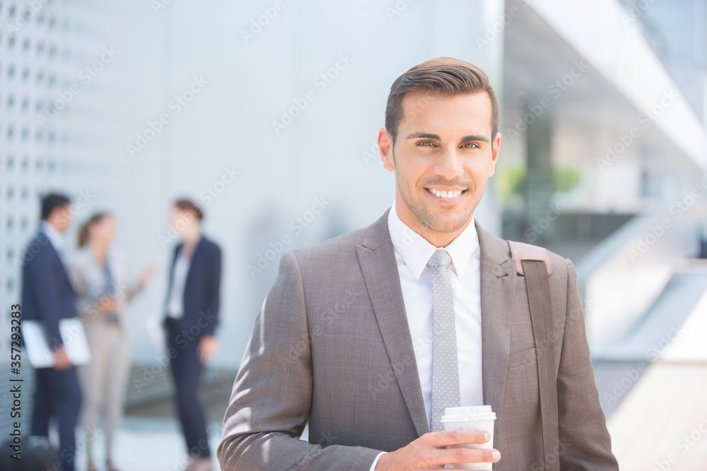 Portrait of confident businessman with coffee outdoors Portrait of confident businessman with coffee outdoors
