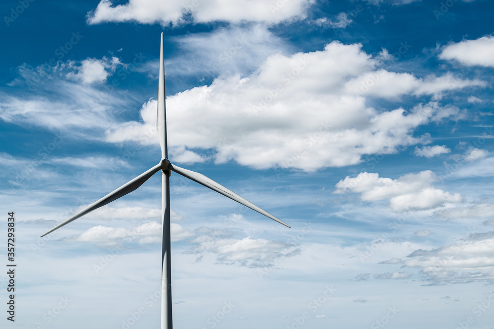 Wind turbineagainst blue sky with clouds on Whitelee wind farm, Scotland, on a sunny day. Wind turbineagainst blue sky with clouds on Whitelee wind farm, Scotland, on a sunny day.