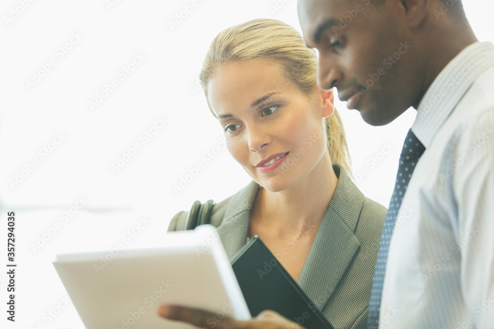 Business people using digital tablet in office Business people using digital tablet in office