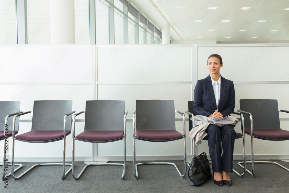Businesswoman sitting in waiting area Businesswoman sitting in waiting area