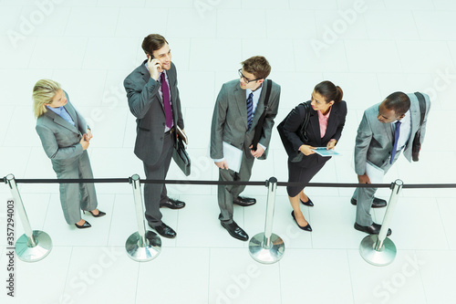 Slika na platnu Businessman talking on cell phone in waiting area
