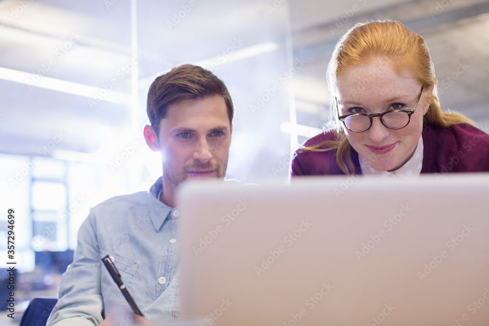Business people using laptop in office Business people using laptop in office