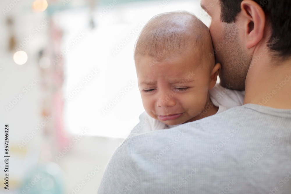 Father holding crying baby boy Father holding crying baby boy