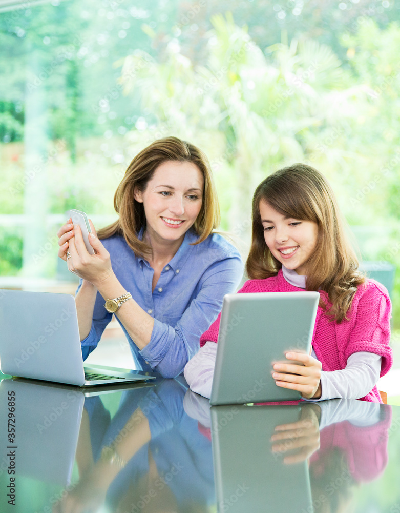 Mother and daughter using technology Mother and daughter using technology