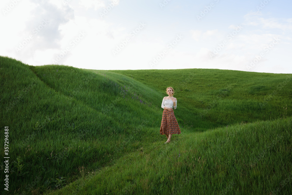 Girl walks on the green hills. High quality photo Girl walks on the green hills. High quality photo
