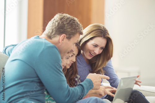 Family using laptop in living room © Martin Barraud/KOTO