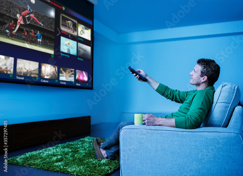 Fotografía Man watching television in living room
