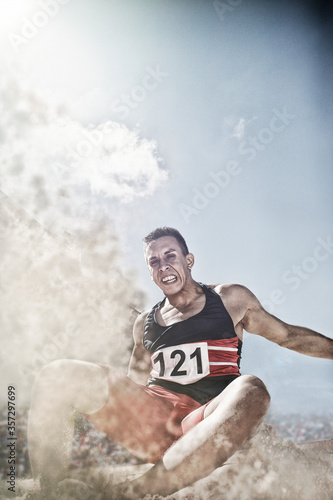 Long jumper landing in sand