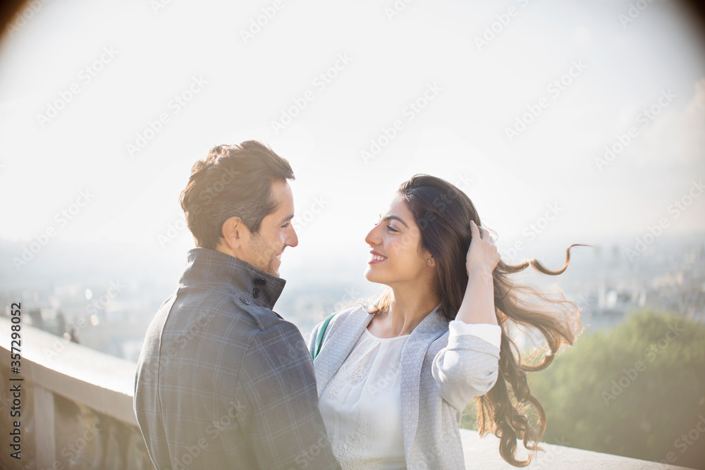 Couple hugging on urban balcony Couple hugging on urban balcony