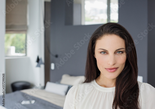Portrait of confident woman in bedroom