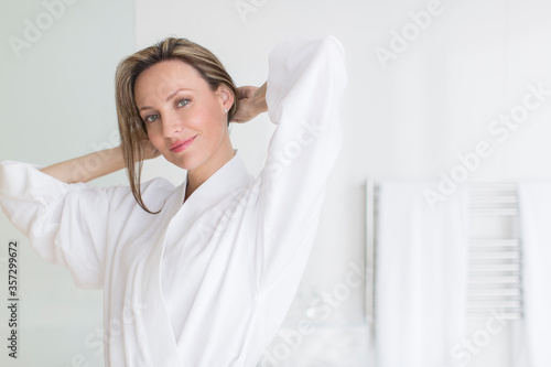 Smiling woman wearing bathrobe