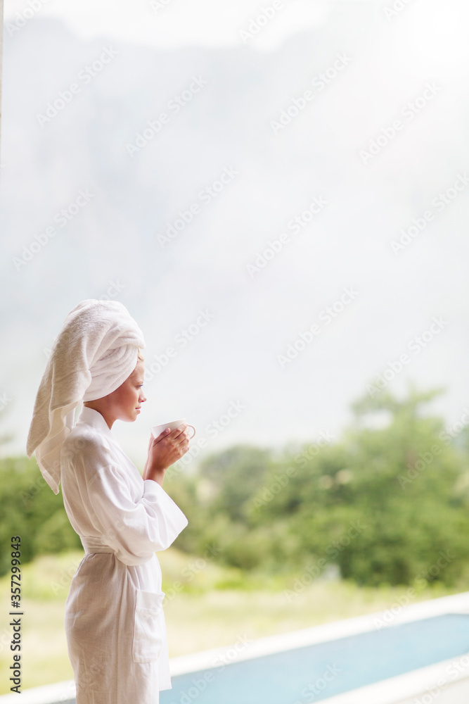 Woman in bathrobe drinking coffee outdoors