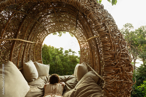 Woman laying in nest tree house