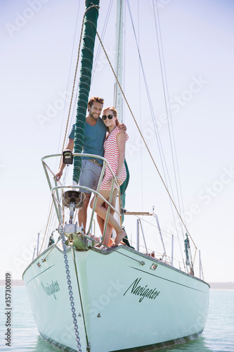 Couple standing on front of boat  © Robert Daly/KOTO