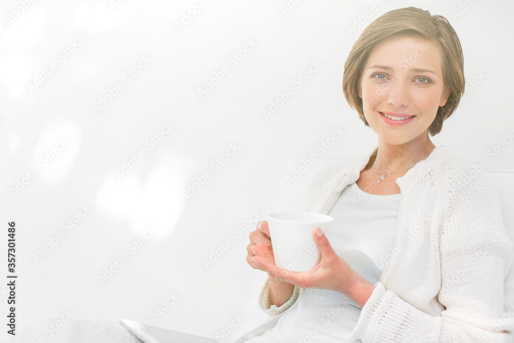 Woman drinking coffee and using digital tablet outdoors Woman drinking coffee and using digital tablet outdoors