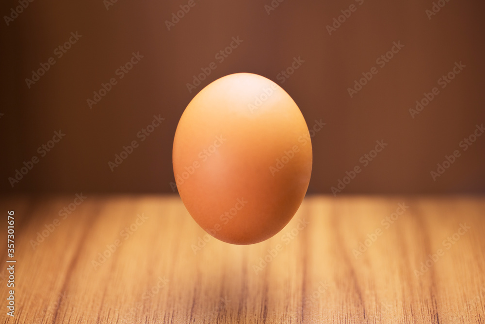 Close up of egg hovering over counter Close up of egg hovering over counter