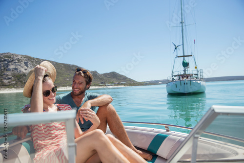 Couple sitting in boat on water  © Robert Daly/KOTO