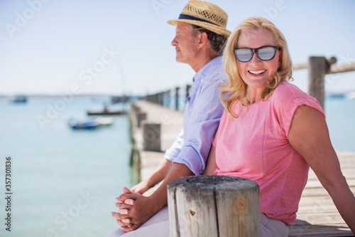 Couple holding hands together on wooden dock
