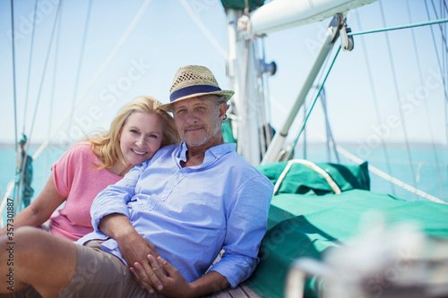 Couple sitting on deck of sailboat