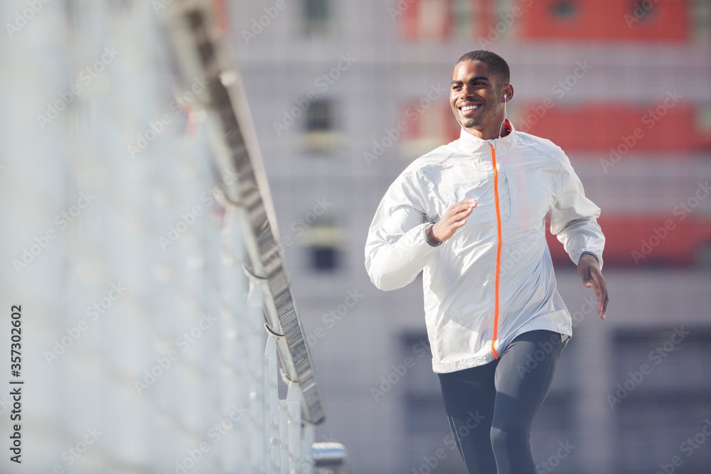 Man running through city streets Man running through city streets