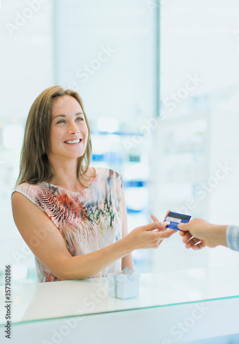 Woman paying with credit card in drugstore