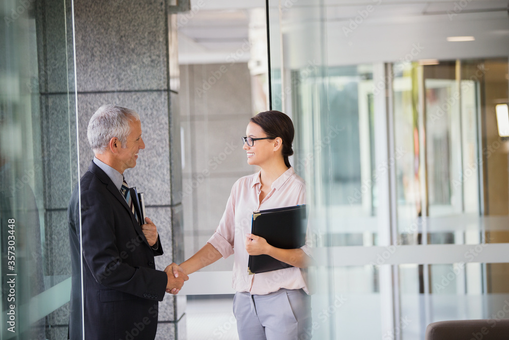 Business people shaking hands in office building Business people shaking hands in office building