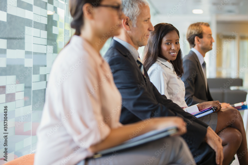 Business people sitting in office together Business people sitting in office together