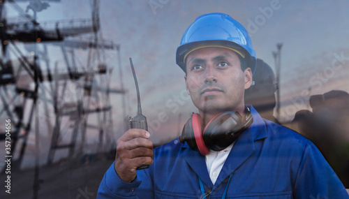 Worker holding walkie-talkie near window