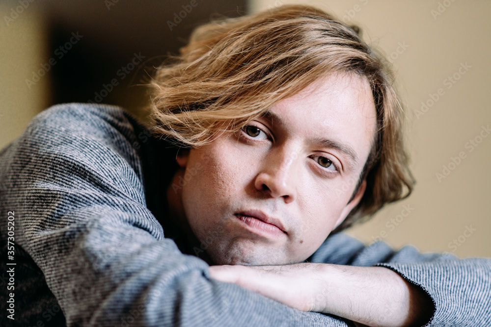 Handsome young man with blond hair looks thoughtfully to the side, dreams and goals in his thoughts, pensive and dreamy shot Handsome young man with blond hair looks thoughtfully to the side, dreams and goals in his thoughts, pensive and dreamy shot