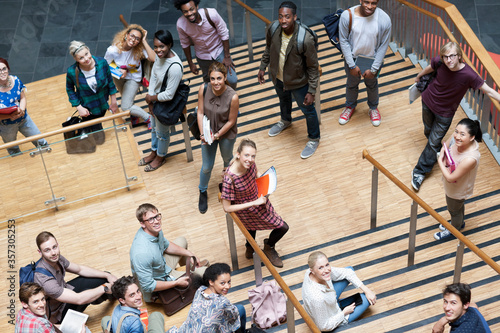 Photography Portrait of university students standing together on staircase
