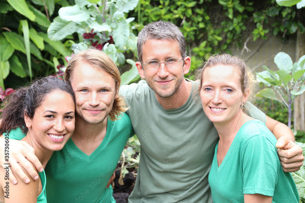 Portrait of four men and women wearing green t-shirts in garden Portrait of four men and women wearing green t-shirts in garden