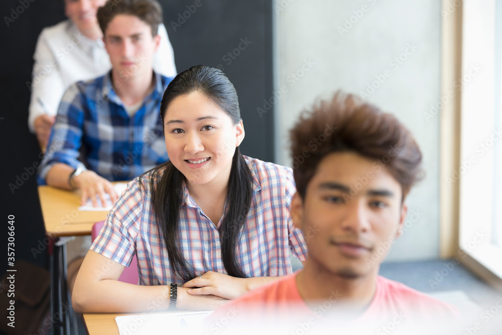 Portrait of smiling university students sitting in classroom Portrait of smiling university students sitting in classroom