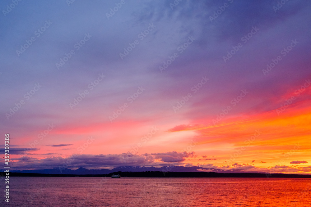 The golden rays of sunset over the ocean water The golden rays of sunset over the ocean water