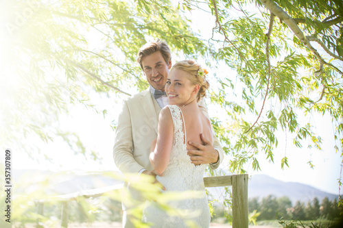 Free Download Portrait of young couple embracing on wooden bridge - GFXLoad