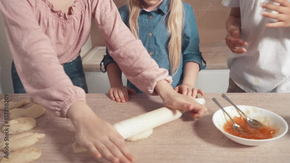 Cute blond children prepare cookies with filling in the kitchen. Cute blond children prepare cookies with filling in the kitchen.