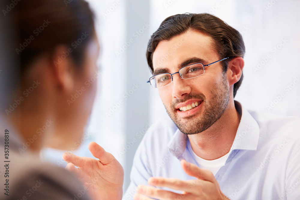 Smiling man in glasses in office with client Smiling man in glasses in office with client