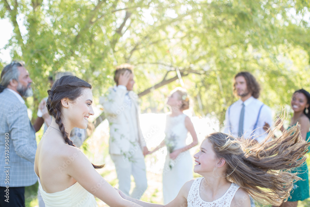 Bridesmaid girl dancing during wedding reception in domestic garden Bridesmaid girl dancing during wedding reception in domestic garden