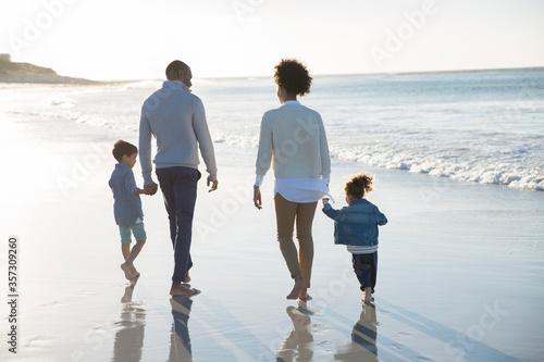 Happy family having fun on beach photo