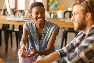 Smiling casual business people talking in office