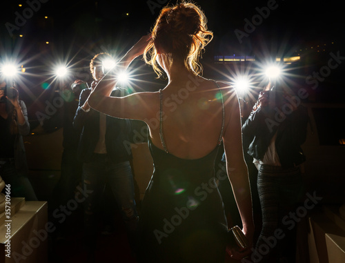 Silhouette of celebrity being photographed by paparazzi