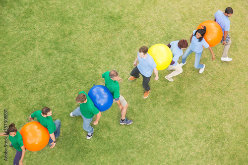 фотографія Teammates performing fitness ball team building activity