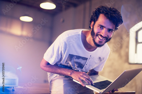 Photography Portrait enthusiastic casual businessman with laptop in office