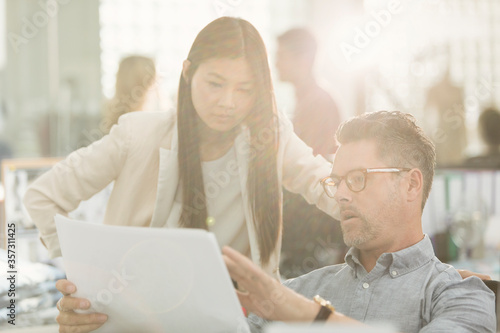 Business people discussing paperwork in office