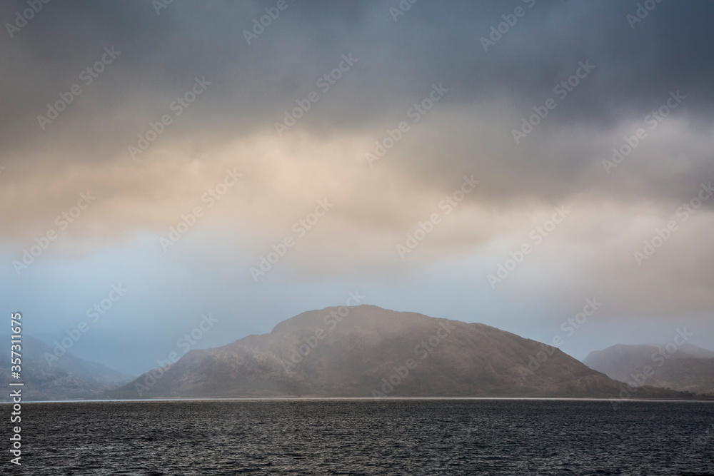Stormy sky over craggy mountains and bay, Port Appin, Argyll Scotland
