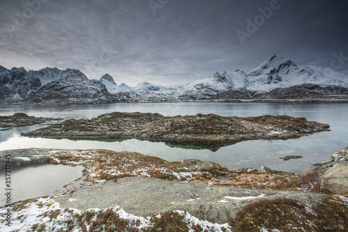 Wallpaper Mural Snow covered mountain range behind craggy bay, Sund, Lofoten Islands, Norway Torontodigital.ca