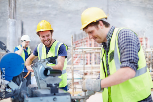 Construction workers using equipment at construction site