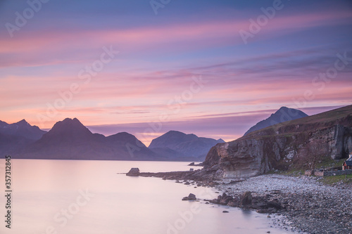 Pink sunset sky over mountains and calm lake, Elgol, Skye, Scotland