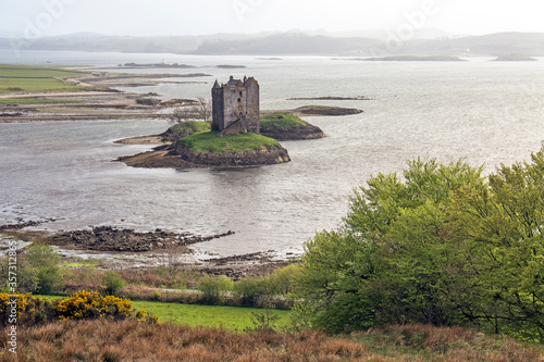 View of island castle on lake, Castle Stalker, Argyll, Scotland photo