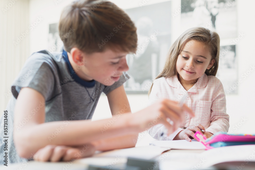 Brother helping sister with homework Brother helping sister with homework