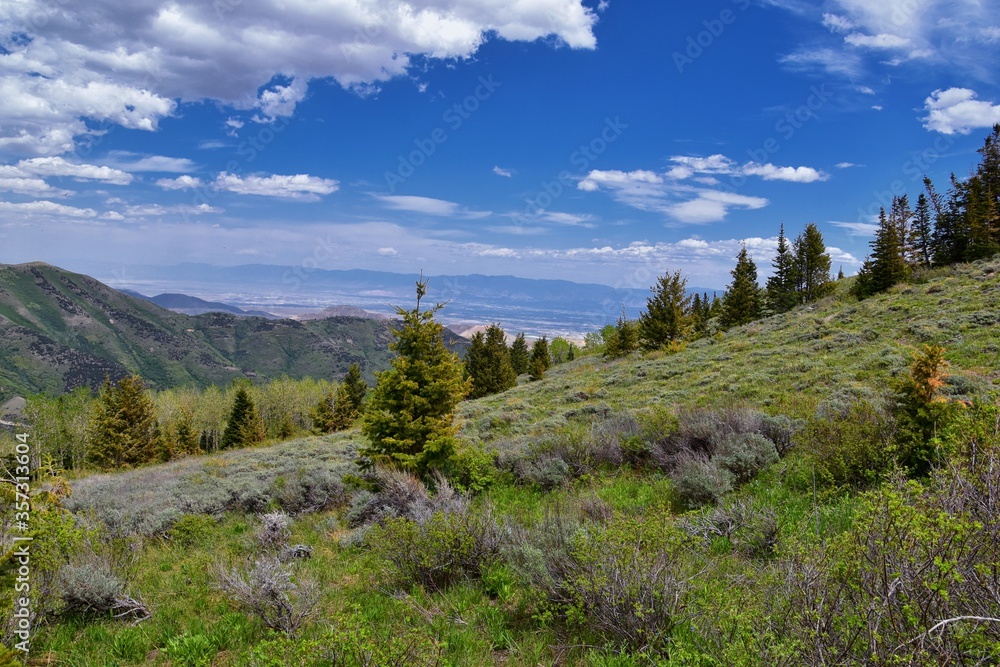 Rocky Mountain Wasatch Front peaks, panorama landscape view from Butterfield Canyon Oquirrh range toward Provo, Tooele Utah Lake by Rio Tinto Bingham Copper Mine, Great Salt Lake Valley in spring. Uta Rocky Mountain Wasatch Front peaks, panorama landscape view from Butterfield Canyon Oquirrh range toward Provo, Tooele Utah Lake by Rio Tinto Bingham Copper Mine, Great Salt Lake Valley in spring. Uta